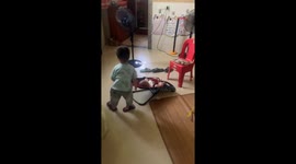 Little brother gently rocks siblings to keep them calm in Guangdong, China