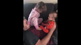 Siblings playfully climb and bond atop their father in Colorado, USA