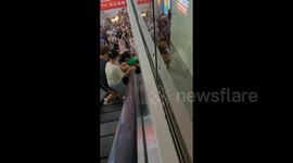 Chaos as boy gets head stuck in narrow gap between escalator and wall