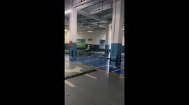 Dog rides electric toy motorcycle in basement parking in Jiangxi, China
