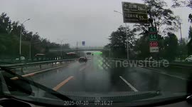 Car loses control on slippery road during rain in Beijing, China