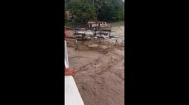 Strong river current floods toward the sea amid typhoon in Hamtic, Antique, Philippines