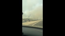 Smoke from Méntrida forest fire seen from A-5 highway in Toledo, Spain