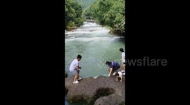 Girl accidentally knocked into river by mother during photo op is rescued safely by crowd