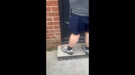 Cat acts as the official door monitor by lying down at the entrance