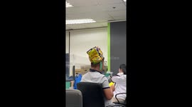 Employees wear amusing wacky hats during work meeting