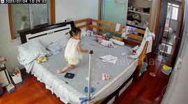 Hilarious moment toddler spinning on the bed falls on floor