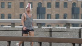 Members of the public attempt to shelter during heavy rain in London with weather warnings for rain and thunderstorms in place