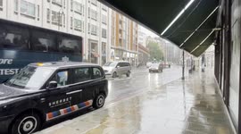 Heavy rain falls in Knightsbridge, Central London.
