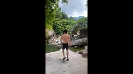 Man slips wearing large slippers while jumping into river in Philippines