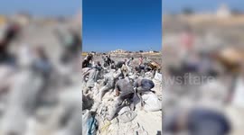 Palestinians collect expired flour from landfill amid israeli blockade in Gaza