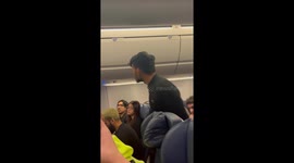 Shocking moment passenger KICKS police officer whilst being removed off plane in Florida