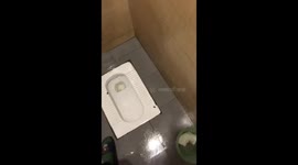 Squat toilet with hole malfunctions and sprays upward in Heilongjiang, China