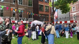 The Belles of London City Morris Dancers' horse surprises a small dog at this years Soho Fete