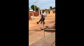 Young boy performs traditional stick dance in Parakou, Benin