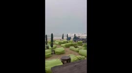 Deckchairs fly along beach as Typhoon Wipha is felt on Thai island