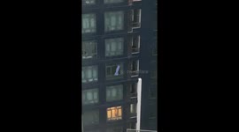 Awning blows from balcony during storm in Bangkok