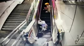 Elderly woman tumbles down escalator, young girl calmly presses stop button