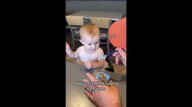 Birthday baby tries custard for the first time, hesitation melts into delight