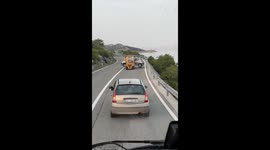Forklift Carries a Car on the Road