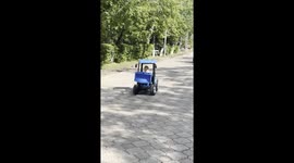 Girl Falls Asleep at the Wheel of a Toy Tractor