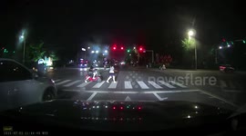 Man pushes electric bicycle towing small vehicle in Shandong, China