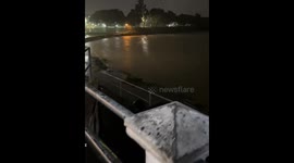 Sudden lightning bolt surprises man near river in Marikina, Philippines