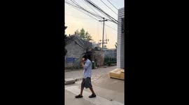 Electrical transformer sparks and smokes after falling on shed in Henan, China