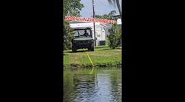 Scuba diver rides John Deere mower out of pond in Florida after accidental splashdown