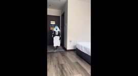 Towel-wrapped robot slips and falls onto bed in Inner Mongolia, China