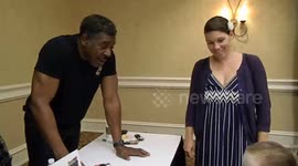 Ernie Hudson having fun with kids dressed up at a convention