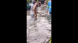 Residents wade through severe floods amid heavy rain in the Philippines