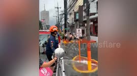Rescue team helps stranded students board on amphibian unit amid flooding