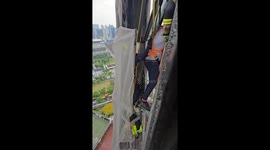 Two window cleaners rescued 400ft up Raffles City Tower in Singapore