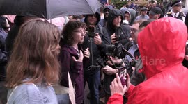 Green Party Councillor Nathalie Bienfait argues with anti migrant protestors during demonstration outside outside the Britannia International Hotel in Canary Wharf in east London