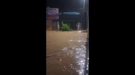 Men risk their lives to pull back belongings swept away by floodwaters