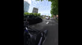 Woman on bicycle falls after crossing red light in front of motorcycle in Rotterdam, Netherlands