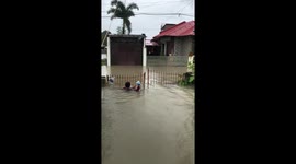 Man wades through neck-deep flood during typhoon in Calumpit, Bulacan, Philippines