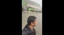 Driver battles to save stranded car as floods swamp the Philippines