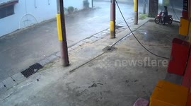 Scooter rider narrowly avoids being crushed when car wash roof collapses