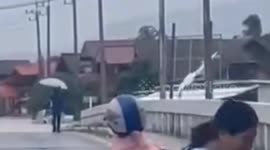 Flash floods sweep car off bridge as rain batters northern Thailand