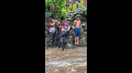 Stranded hikers evacuated as river surges in the Philippines