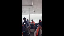 Tour boat braves stormy seas returning to port near Phuket, Thailand