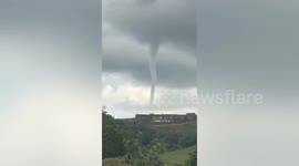 Dramatic footage shows large 'tornado' tearing through British countryside