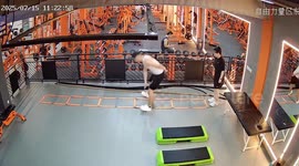 Gymgoer cheats while trainer leads the way with ladder squat jumps