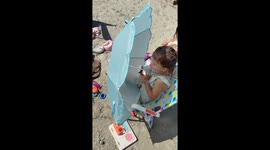 Little Girl and Her Favorite Lemon at the Beach