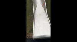Little girl slips and falls from wet slide despite mother's warning about safety