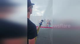 Firemen spray hose on children in Tennessee to cool off