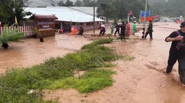 Rescue teams carry school supplies through surging floods in Thailand