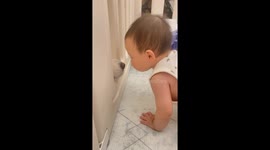Baby in crib gently touches dog's nose with forehead